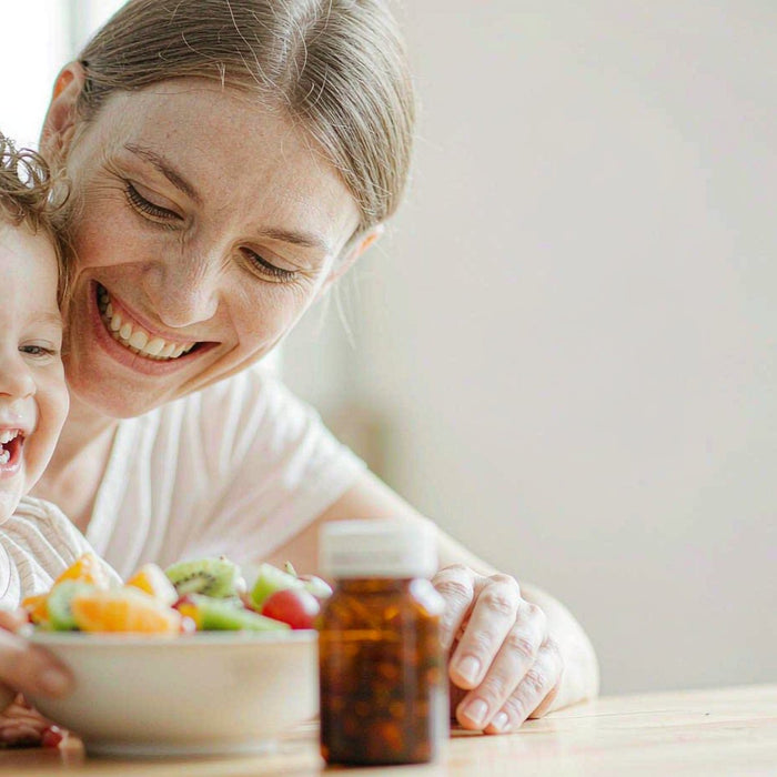 Fair-skinned Caucasian mother and child at a bright breakfast table with a gummy bottle and fruit in